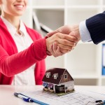 Business partnership. House agent greeting customer in office